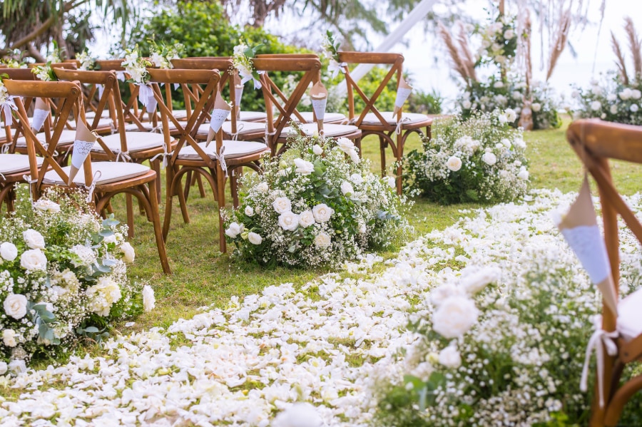 Rows of rental chairs set for an outdoor ceremony